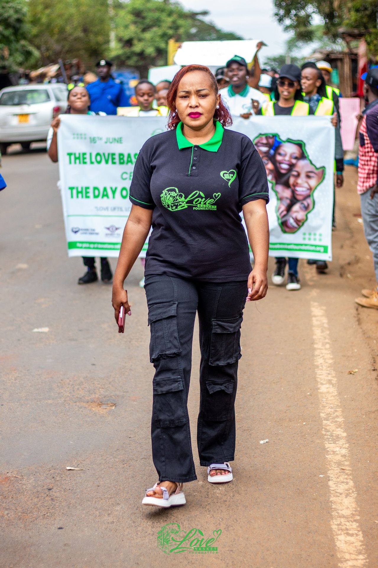 Rev. Eva CW leading The Love Basket Foundation community march